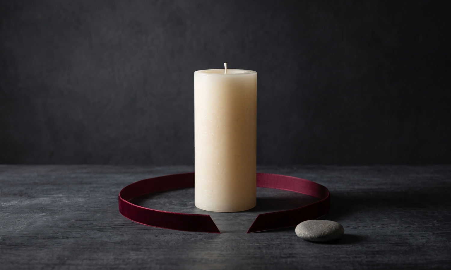Unlit white candle inside a cut ribbon symbolizing healthy boundaries
